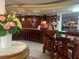 a salon with a vase of flowers on a table at Asia Hotel Can Tho in Can Tho