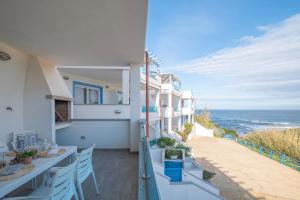 a balcony of a building with a view of the ocean at Diamante Apartments in Valledoria