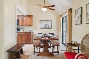a dining room with a table and a ceiling fan at Seascape Villa - 35D in Destin