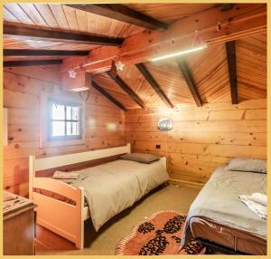 a bedroom with two beds in a log cabin at Sublime Chalet T5 Les Gets in Les Gets