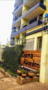 a sign on the side of a building with plants at Sherry Homes - Raha in Nairobi