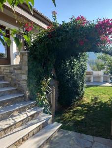 a house with stairs and flowers on it at The Villea Cottage - 5 bed house in Alli Meria in Álli Meriá