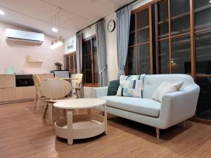 a living room with a couch and a table at Oriental VILLA TRAT ตราด in Trat