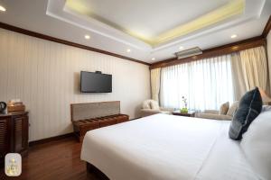 a hotel room with a bed and a television at Thien Thai Hotel & Spa in Hanoi