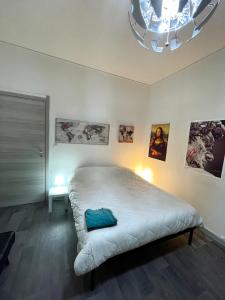 a bedroom with a bed with a blue pillow on it at Pastrengo Home in Alessandria