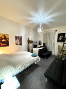 a bedroom with a bed and a living room at Pastrengo Home in Alessandria