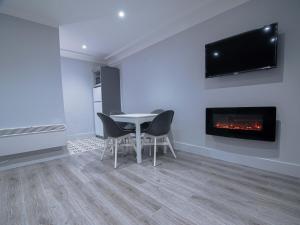 a dining room with a table and a fireplace at City Walk Apts in Dublin