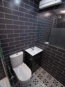 a bathroom with a white toilet and a sink at City Walk Apts in Dublin