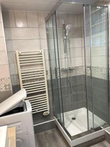 a shower with a glass door in a bathroom at Bourgois in Boulogne-sur-Mer