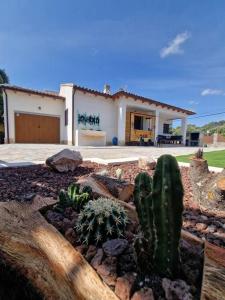 a cactus garden in front of a house at Casa Rural Zahoko in Guadalajara +17 photos
