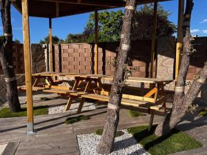 a picnic table and bench under a gazebo at Casa Rural Zahoko in Guadalajara