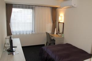 Tempat tidur dalam kamar di Hotel Monteroza Ohta