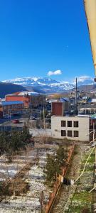 a view of a city with mountains in the background at Guest house in Qusar