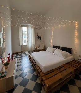 a bedroom with a large bed with lights on the wall at LOGICO #35 HOME in Bari