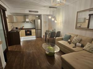 a living room with a couch and a table at intercomerciofeja Experiencia de Lujo in Benalmádena +19 photos