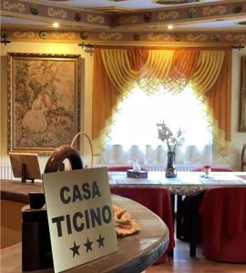 a sign that says casa ricino sitting on a table at Casa Ticino Predeal in Predeal