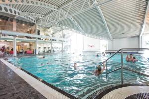a group of people in a large swimming pool at Sherwood 33 in Carnforth