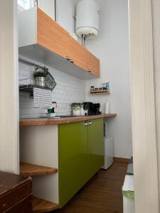 a kitchen with a green cabinet in a room at LOGICO #35 HOME in Bari