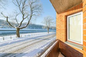 a window on a brick building with snow on the ground at Riverfront 1BD Old Town Apartment by Hostlovers in Kaunas