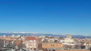 une ligne d'horizon avec des bâtiments et des montagnes en arrière-plan dans l'établissement Apartamento de 2 habitaciones entre La Peseta y Carabanchel Alto con vistas, à Madrid