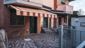 a building with an awning on the side of it at Casa Gioia a 5 minuti da San Marino in Montescudo