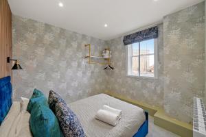 a bedroom with a bed and a window at BridgeCity Spectacular Morden 2 bedroom flat in Ashford Town Centre in Kent