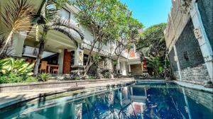 a swimming pool in front of a house at Griya Umadui Bali in Ketewel