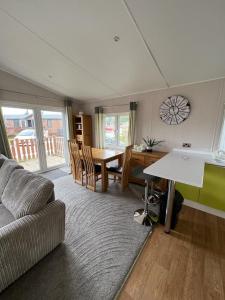 a living room with a couch and a table at Sherwood 33 in Carnforth