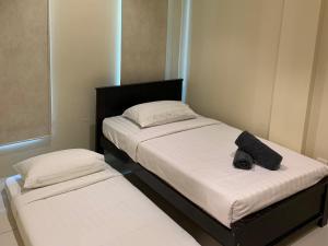 Postel nebo postele na pokoji v ubytování Dango Homestay by Mimpi B&B
