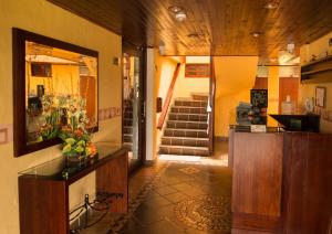 a room with a lobby with a counter with flowers on it at Hotel La Libertad in Paipa
