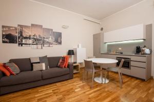 a living room with a couch and a table at Stylish Navigli Apartment - Walk to Darsena & Duomo in Milan
