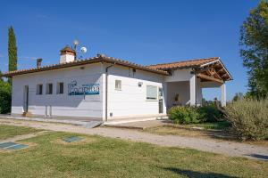 a house with a sign on the side of it at Residenza Principina in Principina Terra