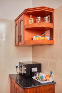 un bancone della cucina con macchinetta del caffè e piatto di cibo di Mama's Home Stay a Dodoma