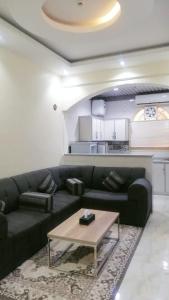 a living room with a couch and a coffee table at شقق روز شروره للشقق المخدومة in Sharurah