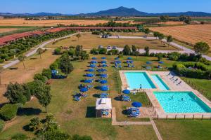 an aerial view of a pool with umbrellas and chairs at Residenza Principina in Principina Terra