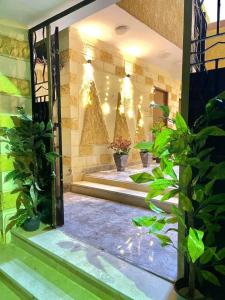 a courtyard with plants and lights in a building at Secret of Horus in Cairo