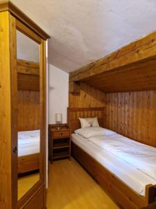 a bedroom with two bunk beds and a doorway at Almhof Grub in Wagrain