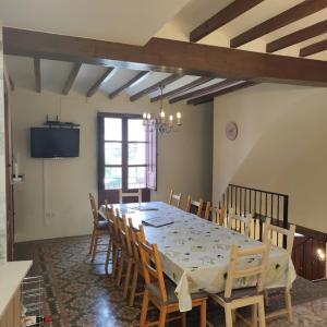 a dining room with a long table and chairs at Casa Pp in Finestrat