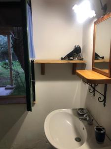 a bathroom with a sink and a mirror at Villette Monte Alto in Patti
