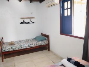 a room with a bed and a table on the wall at Pousada Maravilha Itacaré in Itacaré
