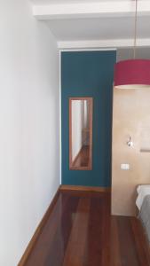 a bedroom with a bed and a mirror on the wall at Villa F&B in Bocas Town