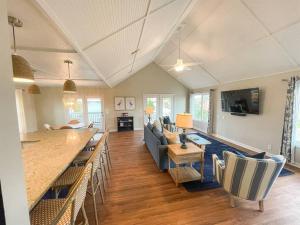 a living room with a couch and a kitchen and a table at The Gentleman Pirate in Edisto Island