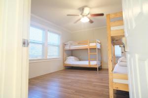 a room with bunk beds and a ceiling fan at Kohzy ( Koreatown ) in Los Angeles