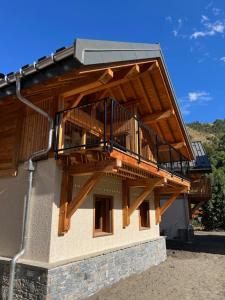 a house with a balcony on the side of it at Galibier & Spirit in Valloire