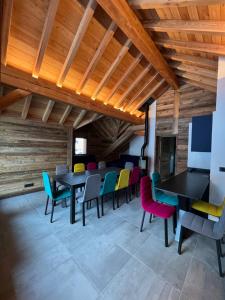 a dining room with tables and colorful chairs at Galibier & Spirit in Valloire