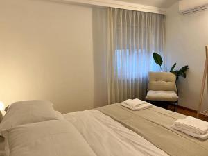 - une chambre avec un lit, une chaise et une fenêtre dans l'établissement Chic Deluxe Villa, à Iaşi