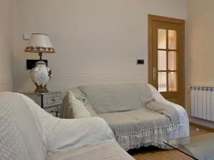 a living room with a chair and a lamp at Bois Argentine by ARoom VUT-LE-1079 in León +26 photos