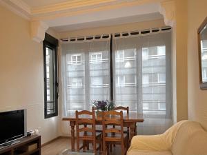 a dining room with a table and chairs and a window at Bois Argentine by ARoom VUT-LE-1079 in León