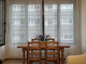 a dining room table with two chairs and a window at Bois Argentine by ARoom VUT-LE-1079 in León