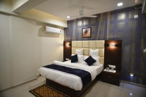 a bedroom with a large bed in a room at Hotel Royal Residency in Vadodara